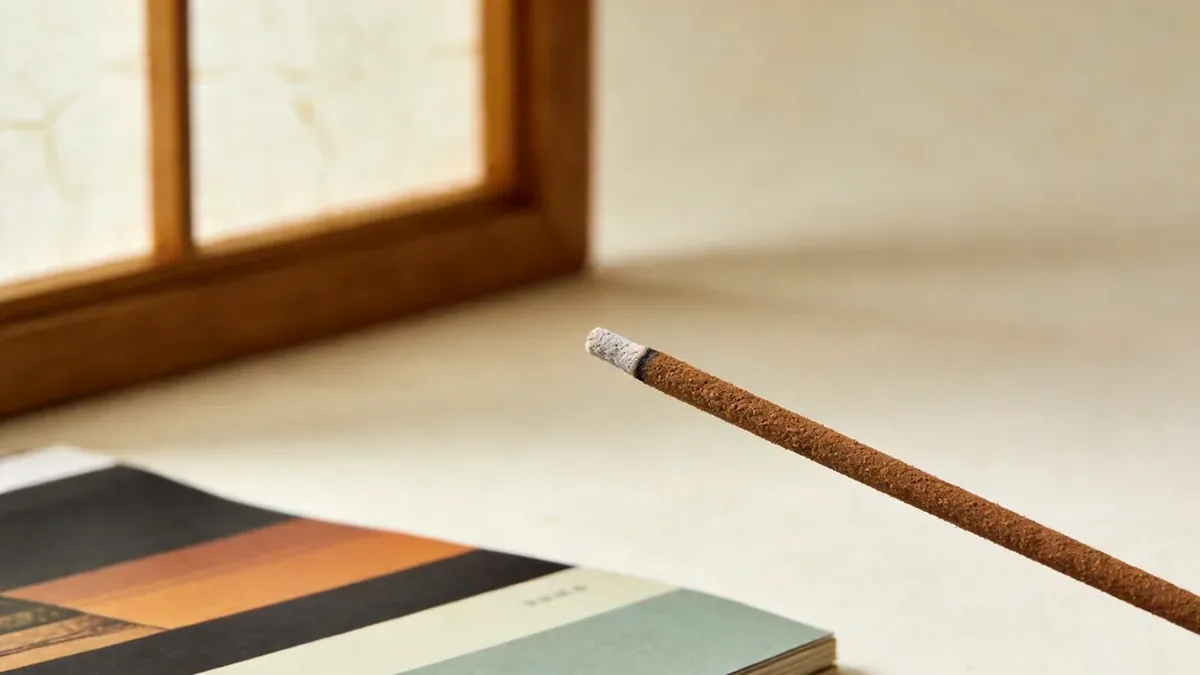 Macro close-up of a premium incense stick with even coating and pale ash