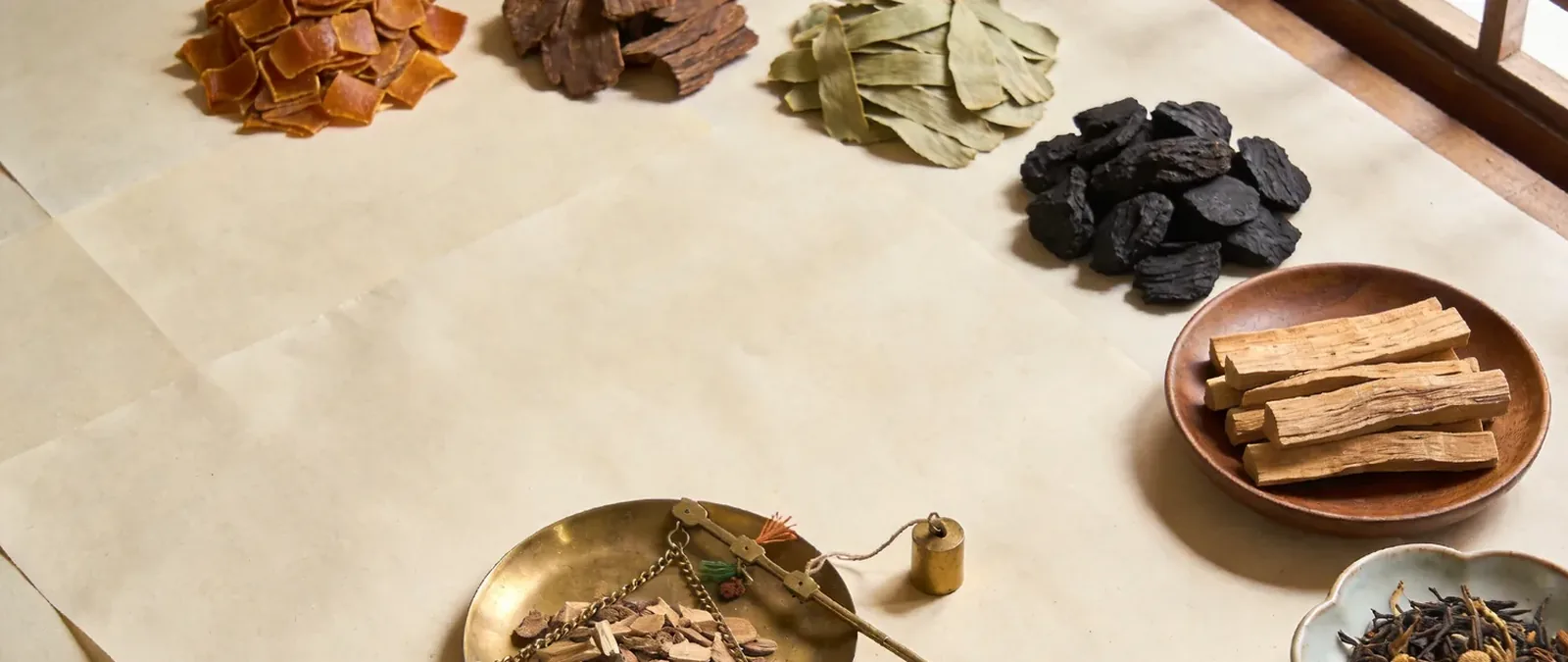 Wide still life of Chinese incense ingredients on rice paper